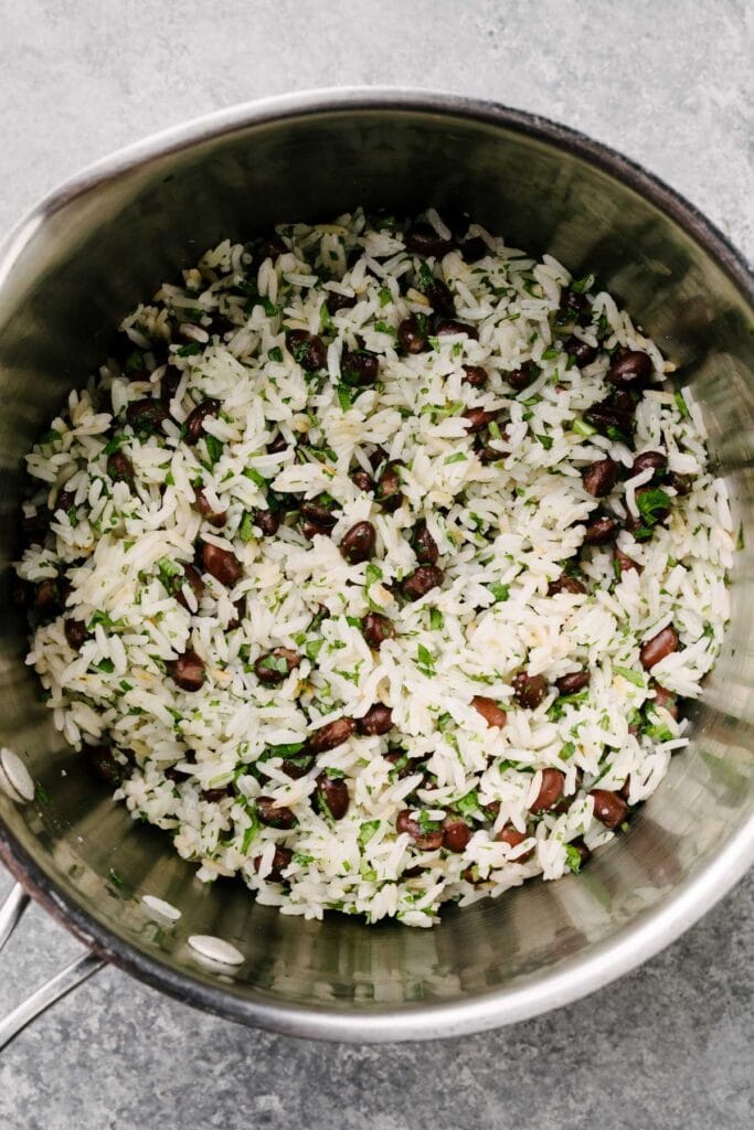 Black beans and rice with cilantro and lime juice in a saucepan.