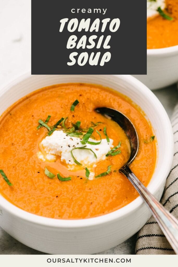 Side view, a spoon tucked into a bowl of fresh tomato basil soup garnished with ricotta cheese and basil; title bar at the top reads "creamy tomato basil soup".