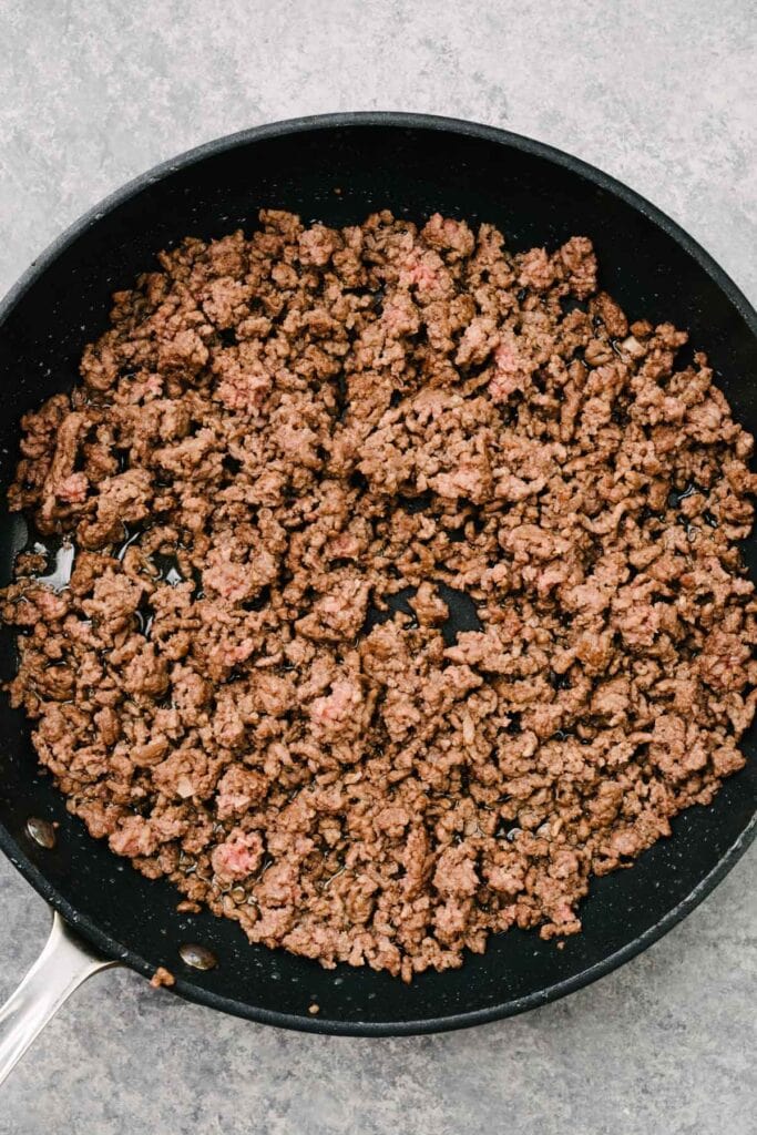 Cooked ground beef in a skillet.