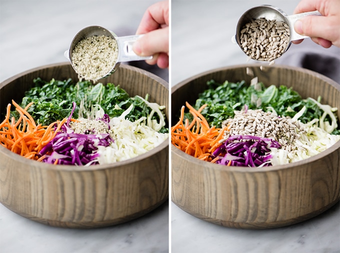 A woman's hand adding hemp seeds then sunflower seeds to crunchy kale slaw.