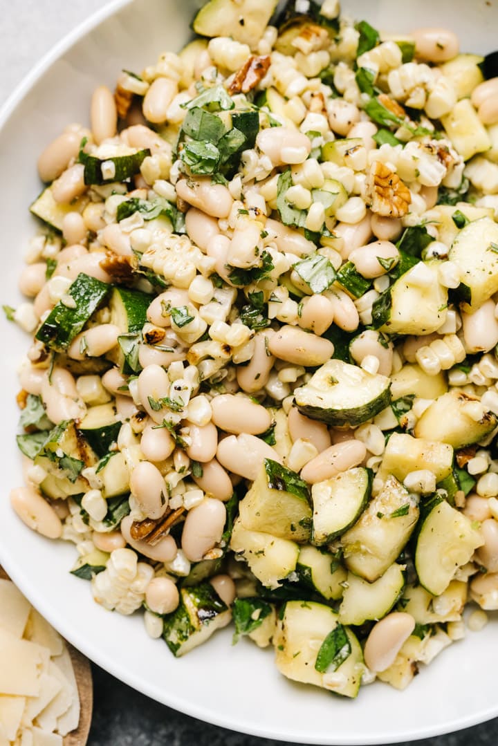 Grilled zucchini salad in a white bowl. 