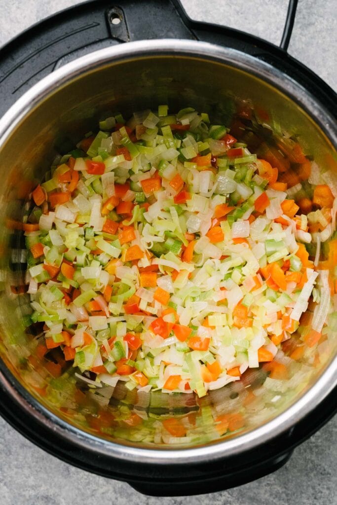 Sautéed onions, leeks, celery, and red bell pepper in an Instant Pot.