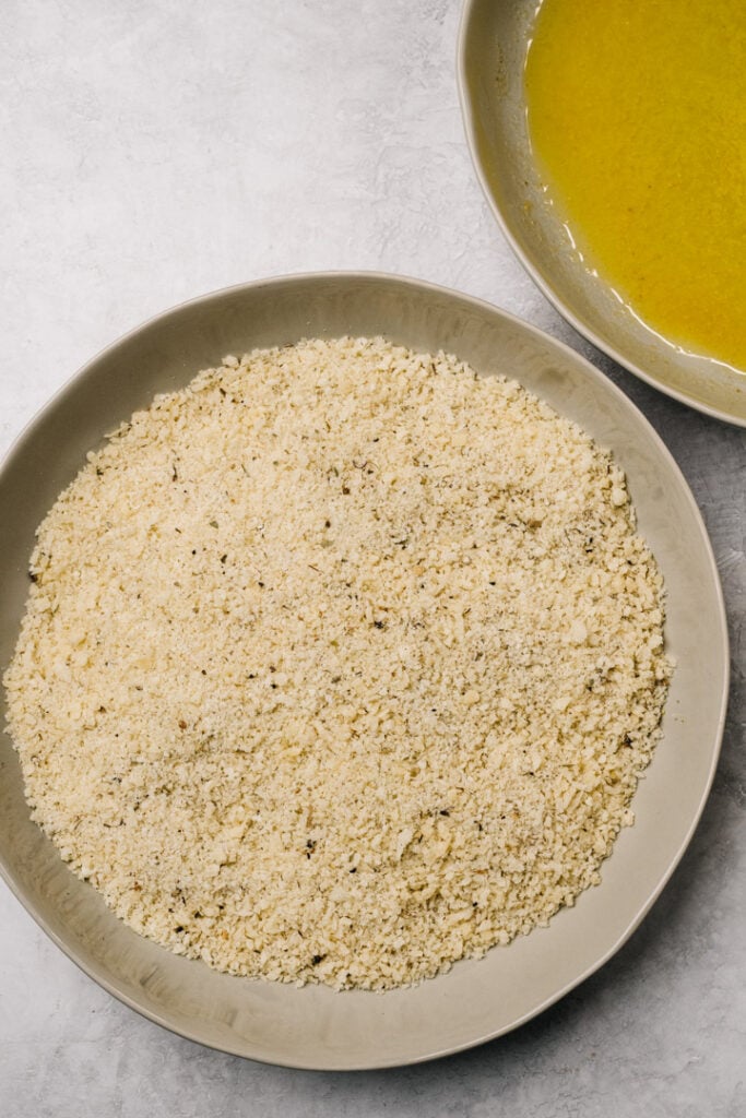 Breadcrumbs in a shallow bowl mixed with seasonings.