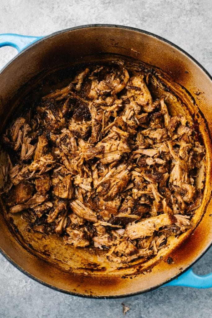 Oven pulled pork in a dutch oven tossed with pan sauces.