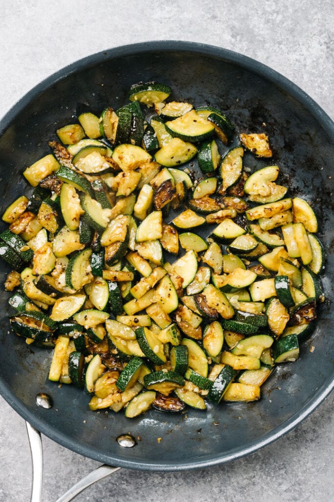 Sauteed zucchini in a skillet.