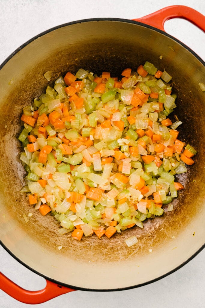 Sautéed onions, carrots, celery, and garlic in a dutch oven.