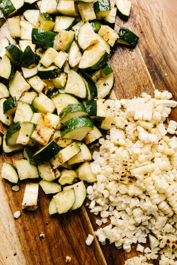 Cut zucchini and corn. 